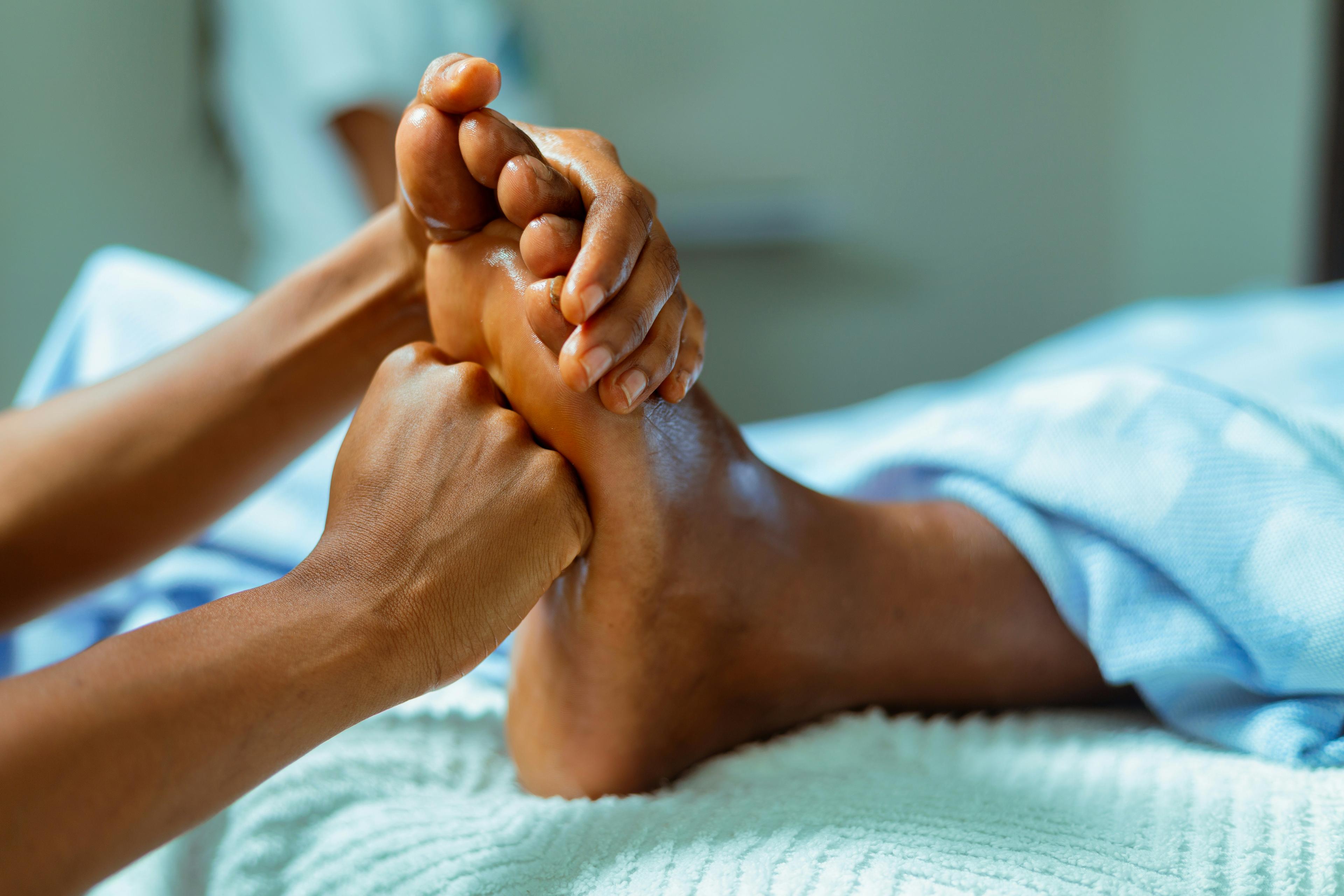 Trained professional providing gentle foot care to an elderly person