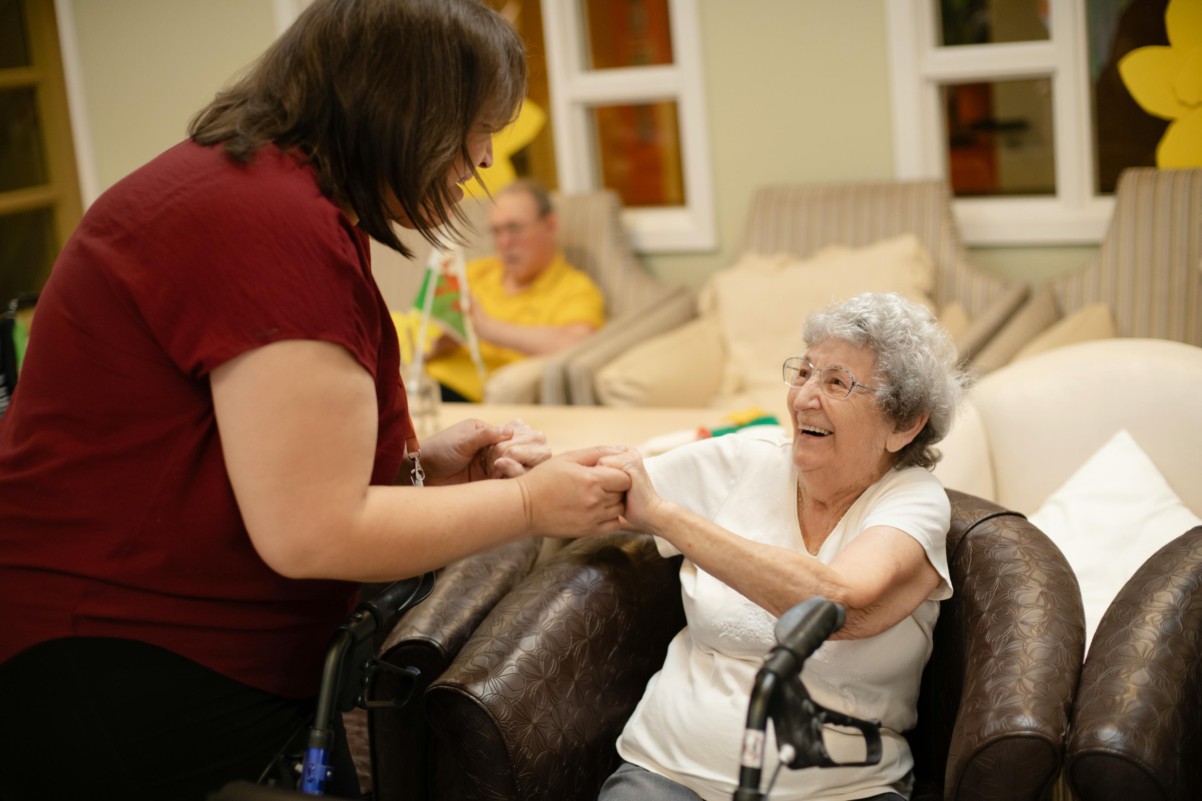 Caregiver supporting a senior recovering at home after hospital discharge