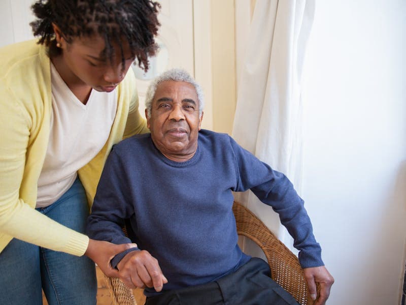 Senior receiving attentive temporary care from a professional caregiver