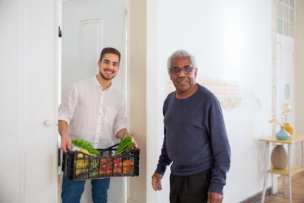 Nurse providing attentive long-term care to senior patient